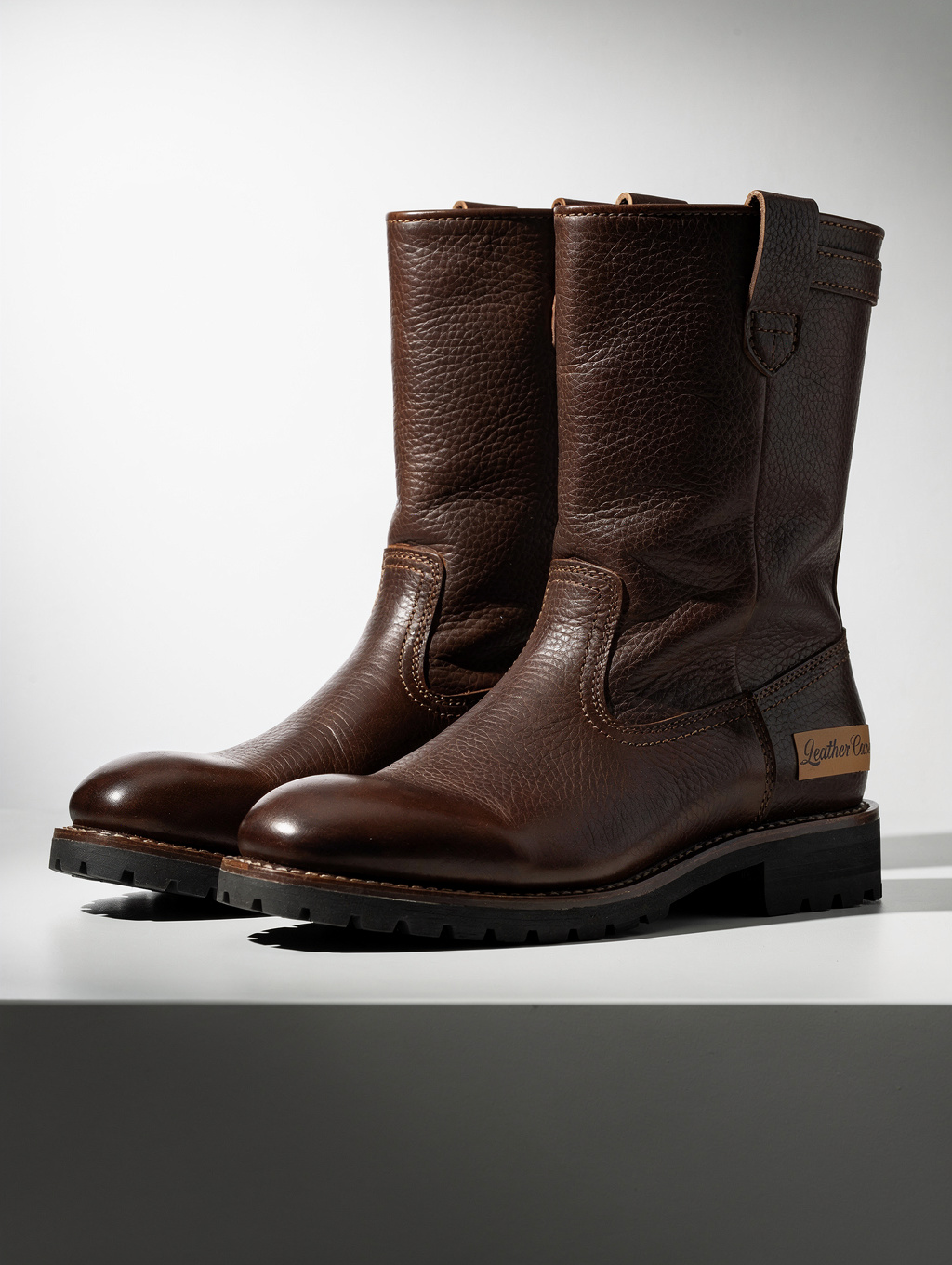 Premium men's leather boots in studio setting